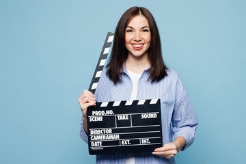 Young happy Caucasian woman she wears shirt casual clothes hold in hand classic black film making...