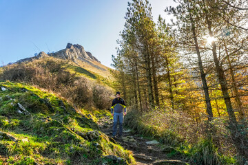 Hiker walking on txindoki mountain trail in gipuzkoa, basque country