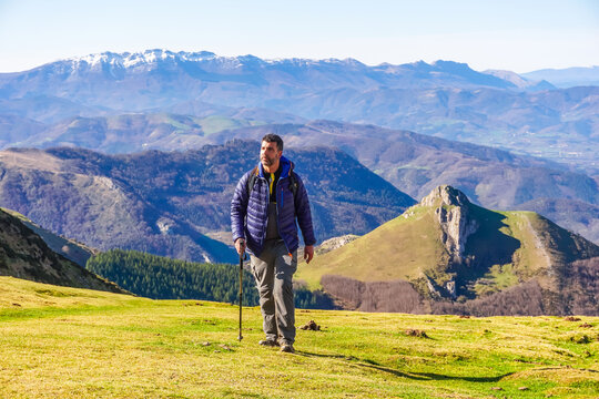 Hiker walking on mount txindoki in the basque country, spain