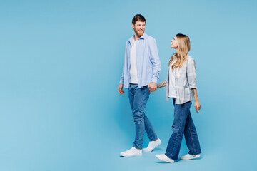 Full body side view young couple two friends family man woman wear shirt casual clothes together...