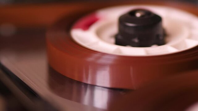 macro vintage audio cassette in tape recorder plays or records music composition, cassette audio tape recorder close-up