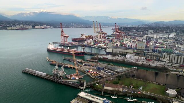 Industrial Port Of Container Terminal With Cargo Ship In Downtown Eastside In Vancouver, Canada. - aerial shot