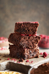 Homemade gluten-free brownies made with red kidney beans, oat flakes, chocolate and freeze-dried raspberries