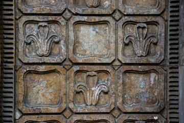 Intricate decorative wall panels showcasing floral designs in a historical building's architecture