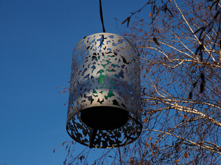 Modern Park Hanging Lantern with Iridescent Light Against Blue Sky, Outdoor Decor