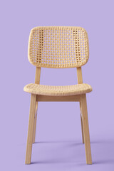 Stylish wooden chair on lilac background