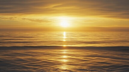 Fototapeta premium A serene seascape at sunrise, golden hues reflecting on the calm ocean waves with a distant horizon.