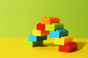 Construction toy. Figure made with building bricks on color background