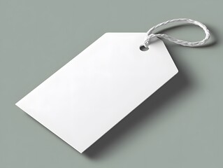An empty white label tag hangs suspended on a grey backdrop