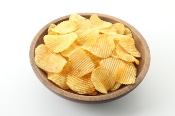 Tasty potato chips in bowl on white background, closeup