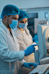 team of doctors man and woman in protective medical clothing working in a modern medical...