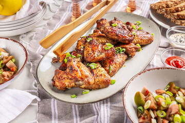 Picnic table and outdoor eating, chicken wings with mixed salad