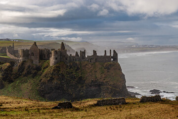 Discover the enchanting ruins of an ancient Dunluce coastal castle, set against a serene seascape Ireland Europe