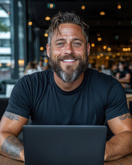 A happy software developer working on a laptop in a high-tech office, modern and sleek setting