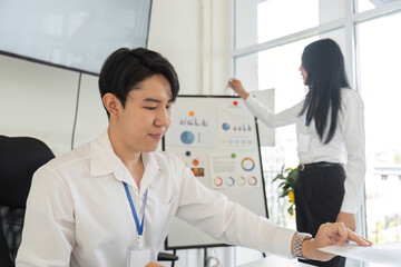 Fototapeta premium Professional analyzing financial data on a digital display in an office setting.