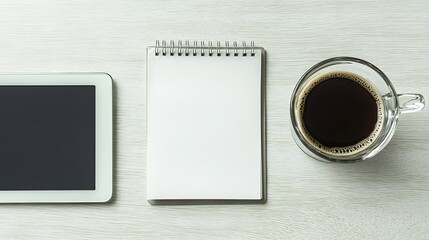 Minimalist Workspace with Tablet, Blank Notepad, and Coffee Cup on Wooden Surface
