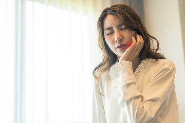 Asian woman suffering from toothache, oral health issues, dental pain and cavity problems, oral...