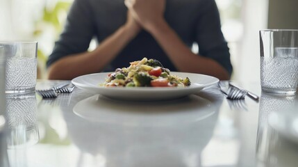 Stomach pain while sitting at a dining table. Featuring concern and reflection