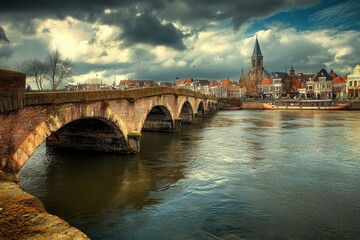 Obraz premium Maastricht - Netherlands. Old Arch Bridge Over Water in European Cityscape