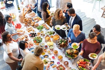 People enjoying a buffet. Buffet table with variety dishes at social event. Happy diverse people chatting and enjoy with food and drink. Buffet table with social gathering, diverse crowd, buffet.