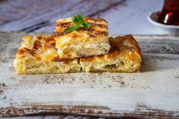 Preparing Traditional Turkish Ramadan Pastry on Wooden Table Photo, Traditional Turkish Cuisine Pastries (Kol böreği, Su Boregi, Sigara Boregi, Rulo Borek) Üsküdar Istanbul, Turkiye (Turkey)