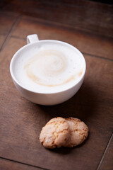 Cappuccino on dark wooden background. Soft focus. Close up.