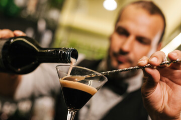 Professional bartender crafting a cocktail at a busy bar