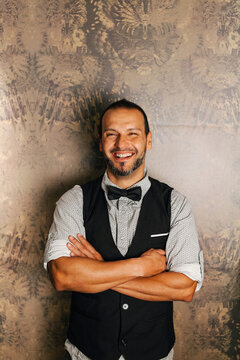 Professional bartender smiling confidently in chic cocktail bar