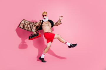 Full length photo of attractive grandpa hold tape recorder dancing have fun wear stylish leopard...