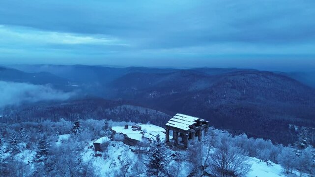 Temple du Donon covered in fresh winter snow, aerial drone view in the Vosges Mountains.