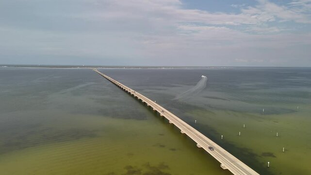 Aerial view circling over the Mid-Bay Toll Bridge, sunny day in Florida, USA