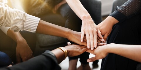 Diverse group of business people's hands showing unity and teamwork. Business people's hands of...