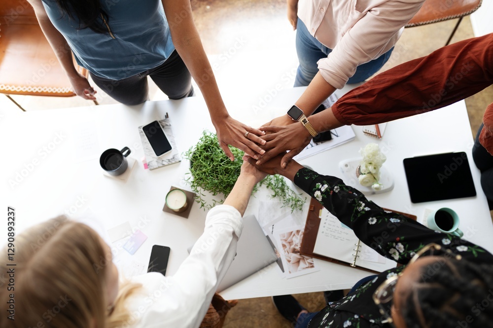Poster diverse business people joining hands over a table, symbolizing teamwork and unity. office setting w