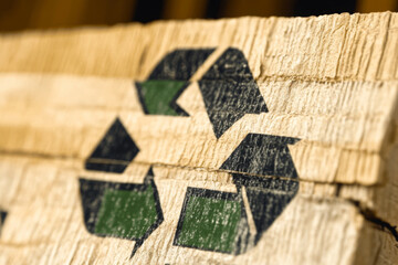 A detailed view of the recycle symbol painted on a wooden surface highlights the importance of sustainability and environmental awareness in communities. Generative AI