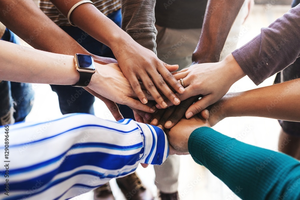 Poster diverse hands of various ethnicities stacked together, symbolizing unity and teamwork. hands of diff