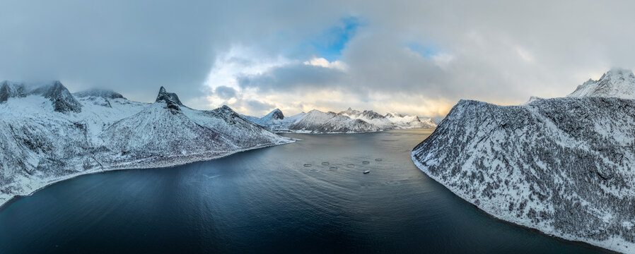 panoramic aerial winter photo over the snowy landscape at Oeyfjorden near Husoey on the Island of Senja in Northern Norway