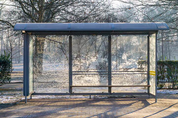 frozen bus stop in city in winter. frozen windows of the bus stop.