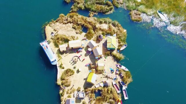 Drone top-view scene of artificial islands with houses and people  floating on Lake Titicaca
