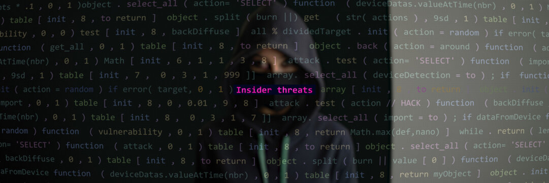 Cyber attack insider threats text in foreground screen, hacker hidden in the blurred background. Vulnerability text in binary system ascii art style, code on editor screen. Text in English