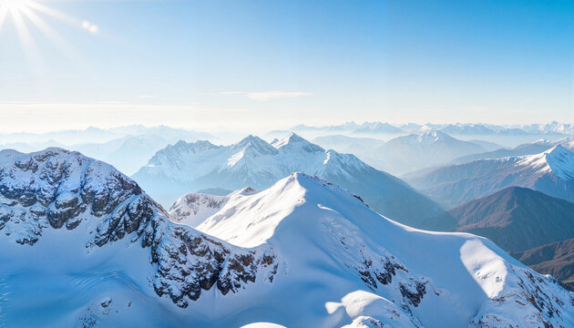Expansive snowy mountain landscape under clear blue sky, natural beauty
