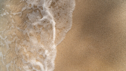 sea wave on sand, top view