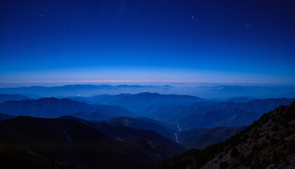 Twilight over serene mountain landscape, peaceful night sky