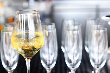 a glass of white wine served in a restaurant, abstract background of a summer restaurant