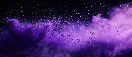Fototapeta premium Vivid purple powder explosion on a black background with dynamic movement and detailed texture creating a dramatic visual contrast and depth