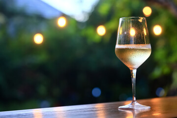 a glass of white wine served in a restaurant, abstract background of a summer restaurant