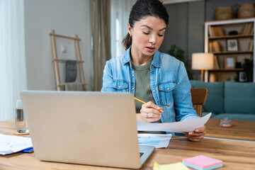 Young happy confident business woman working from home at home office on laptop computer, doing...