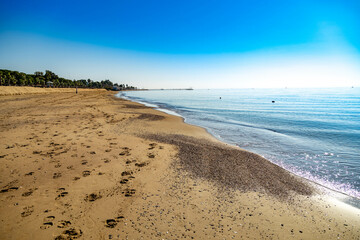 Footprints in sand of empty wide beach on the Mediterranean Sea in low season . Sorgun, Antalya province, Turkey. December