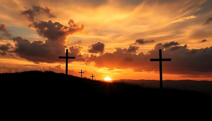 Obraz premium Silhouette of Three Crosses on Hill Against a Vibrant Sunset