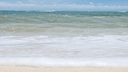 BALI, INDONESIA - JANUARY 22, 2018: Clean sand and beautiful waves background of Pandava Beach and Indian Ocean waves, Bali.