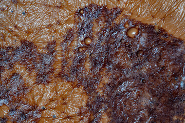 Thick foam on the surface of cocoa drinks, closeup, top view. Backgrounds and texture cocoa milk foam